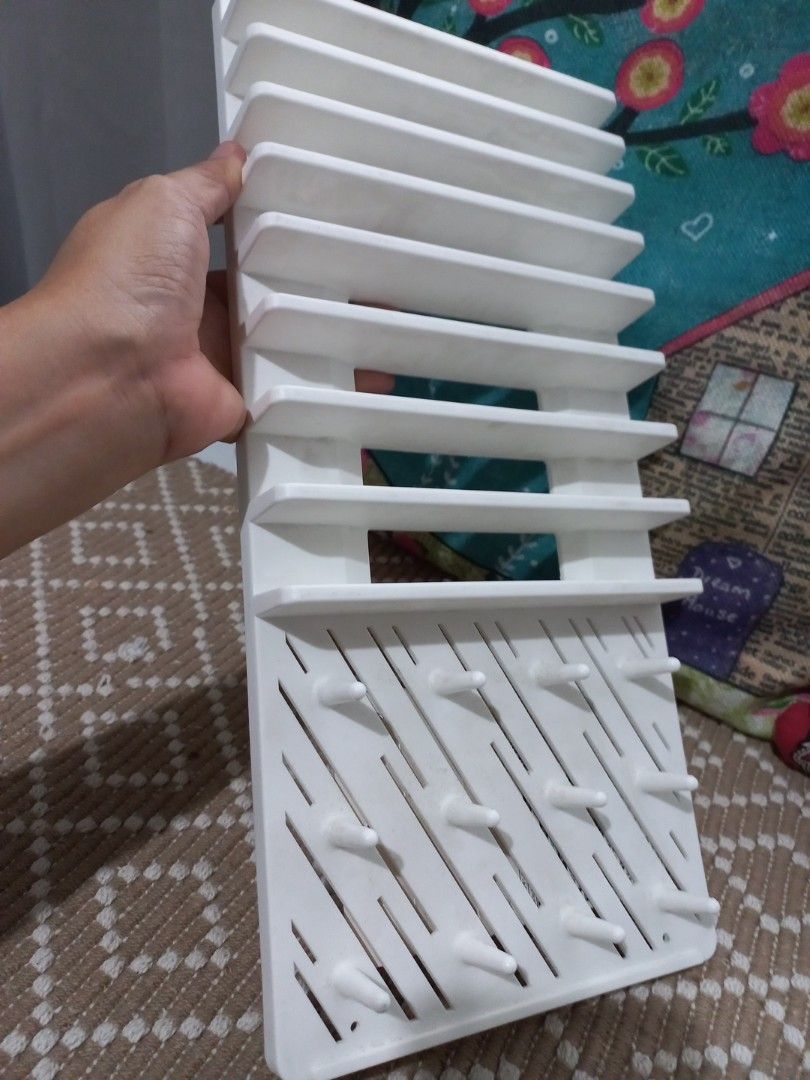 Daiso White Drying Tray Rack for Bottles & Utensils (Category: Breastfeeding & Bottle Feeding) located in Naga. Submitted by greatchance (Listing ID 1455202754, Image 3). Description: - Daiso White Drying Rack - Ideal for baby bottles, straws, and small kitchen utensils - Features multiple pegs and slots for efficient drying - Compact design, measures approx. 37cm x 16.5cm - Brand new and unused.