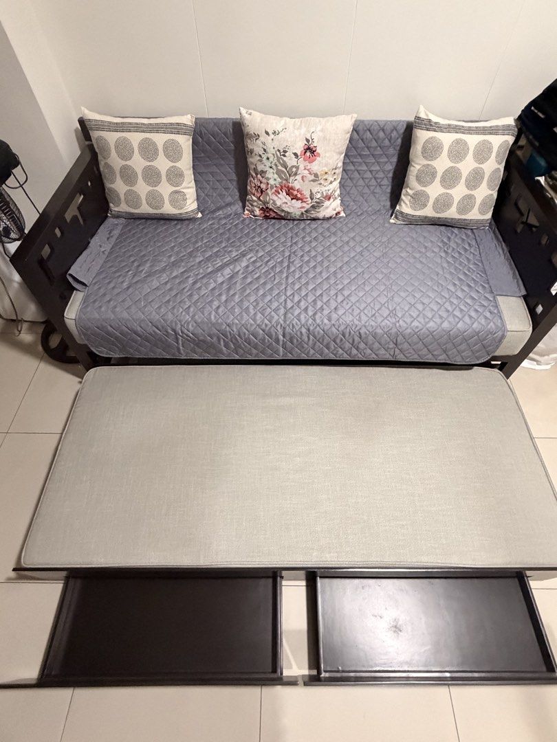 Dark Wood Sofa Bed with Pull-out Trundle and Storage (Category: Sofas) located in Manila. Submitted by miguelfits (Listing ID 1455239505, Image 3). Description: - Dark wood sofa bed with grey quilted fabric - Pull-out trundle for guests - Two built-in storage drawers in trundle frame - Includes 3 decorative pillows - Ideal for small spaces.