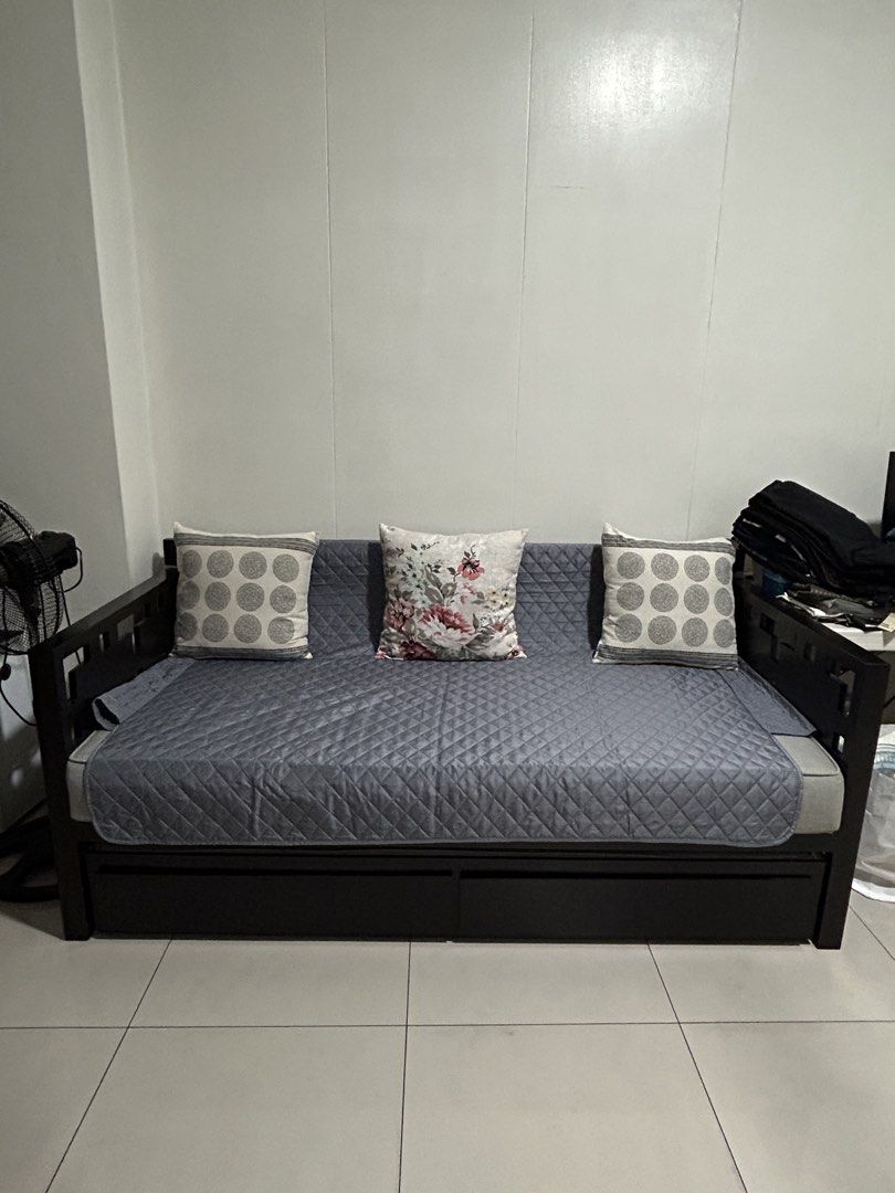 Dark Wood Sofa Bed with Pull-out Mattress and Storage (Category: Sofas) located in San Juan City. Submitted by curatedbymae (Listing ID 1455240926, Image 1). Description: Item: Dark Wood Sofa Bed with Pull-out Mattress and Storage - Versatile Sofa Bed - Dark and solid Wood Frame - Grey Pull-Out Mattress (fabric) - Two Underneath Storage Drawers - Ideal for Small Spaces & Guest Rooms - Easy Sofa-to-Bed Conversion - Quilt cover and 3 decorative pil
