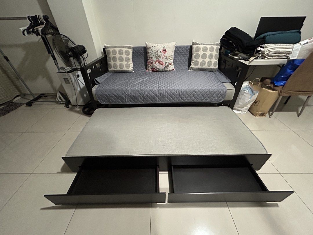 Dark Wood Sofa Bed with Pull-out Mattress and Storage (Category: Sofas) located in San Juan City. Submitted by curatedbymae (Listing ID 1455240926, Image 3). Description: Item: Dark Wood Sofa Bed with Pull-out Mattress and Storage - Versatile Sofa Bed - Dark and solid Wood Frame - Grey Pull-Out Mattress (fabric) - Two Underneath Storage Drawers - Ideal for Small Spaces & Guest Rooms - Easy Sofa-to-Bed Conversion - Quilt cover and 3 decorative pil