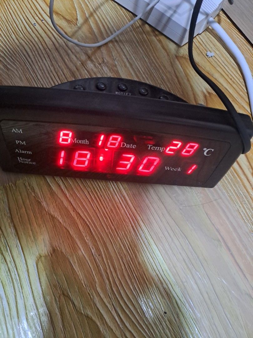Digital Alarm Clock with Temperature and Date Display (Category: Clocks) located in Las Pinas. Submitted by cobieshop (Listing ID 1455255228, Image 1). Description: - Sleek black digital alarm clock - Bright red LED display for clear visibility - Shows time, month, date, temperature, and day of the week - Easy-to-use side buttons for settings - Comes complete with a power cord - Fully functional and works well.