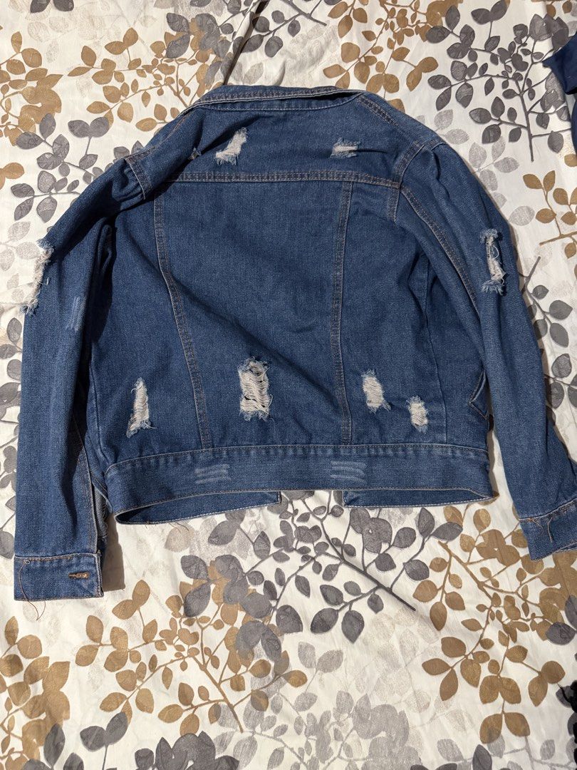 Distressed Blue Denim Jacket Size S (Category: Coats, Jackets and Outerwear) located in Taytay. Submitted by cloudy_20 (Listing ID 1455272596, Image 2). Description: - Cool distressed blue denim jacket - Ripped details on sleeves and back - Button-up front with pockets - Size S up to M.