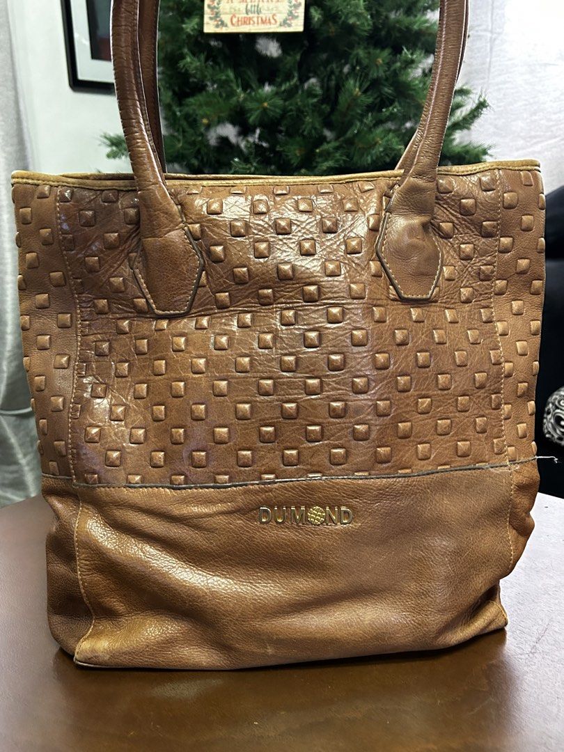 DUMOND Brown Leather Studded Tote Bag (Category: Tote Bags) located in Manila. Submitted by my_krophone (Listing ID 1455211170, Image 3). Description: - Brand: DUMOND - Material: Genuine Leather - Color: Brown - Design: Classic tote shape - Front Panel: Textured with studs - Lower Section: Smooth leather - Interior: DUMOND logo printed lining - Handles: Leather - Ideal for: Everyday use.