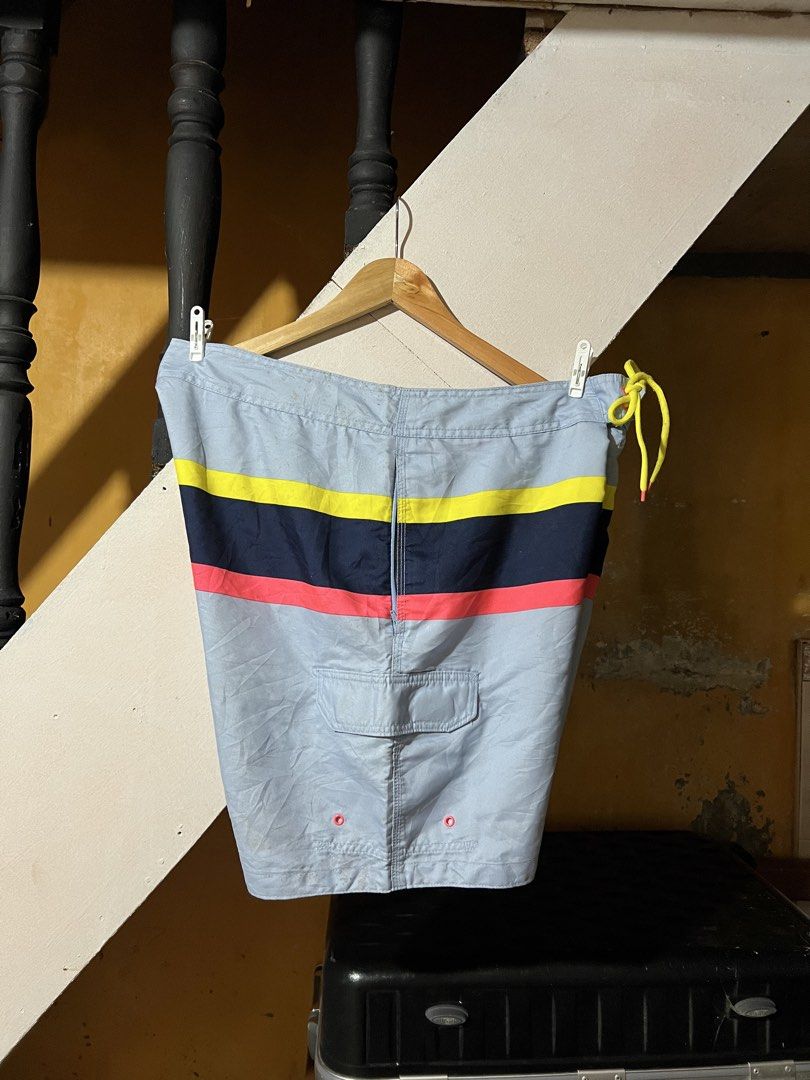 Gap Men's Striped Board Shorts XL (Category: Shorts) located in Butuan. Submitted by nikthrift. (Listing ID 1455254509, Image 3). Description: - Brand: Gap - Size: XL - Color: Light blue with colorful stripes - Features: Cargo pocket on right leg, drawstring waist for adjustable fit - Material: 100% Polyester - Ideal for: Swimming, beach, or casual wear - 36-38 waistline - 19 length.