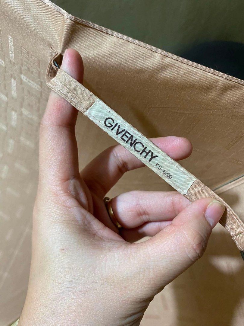 Givenchy Umbrella (Category: Umbrellas) located in Makati City. Submitted by ehloysah (Listing ID 1455310486, Image 2). Description: - Classic Givenchy umbrella - Tan color - Wooden handle with engraved detail - Folds up neatly for storage - Ideal for rainy days.
