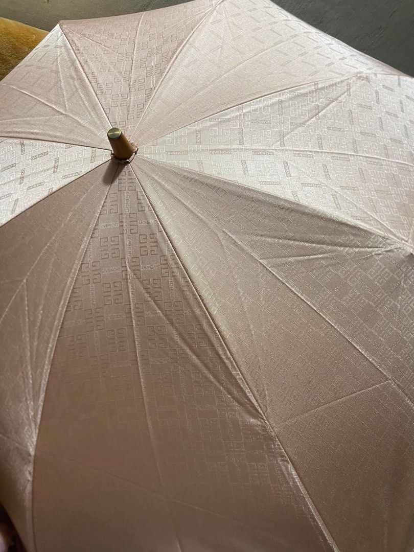 Givenchy Umbrella (Category: Umbrellas) located in Makati City. Submitted by ehloysah (Listing ID 1455310486, Image 3). Description: - Classic Givenchy umbrella - Tan color - Wooden handle with engraved detail - Folds up neatly for storage - Ideal for rainy days.