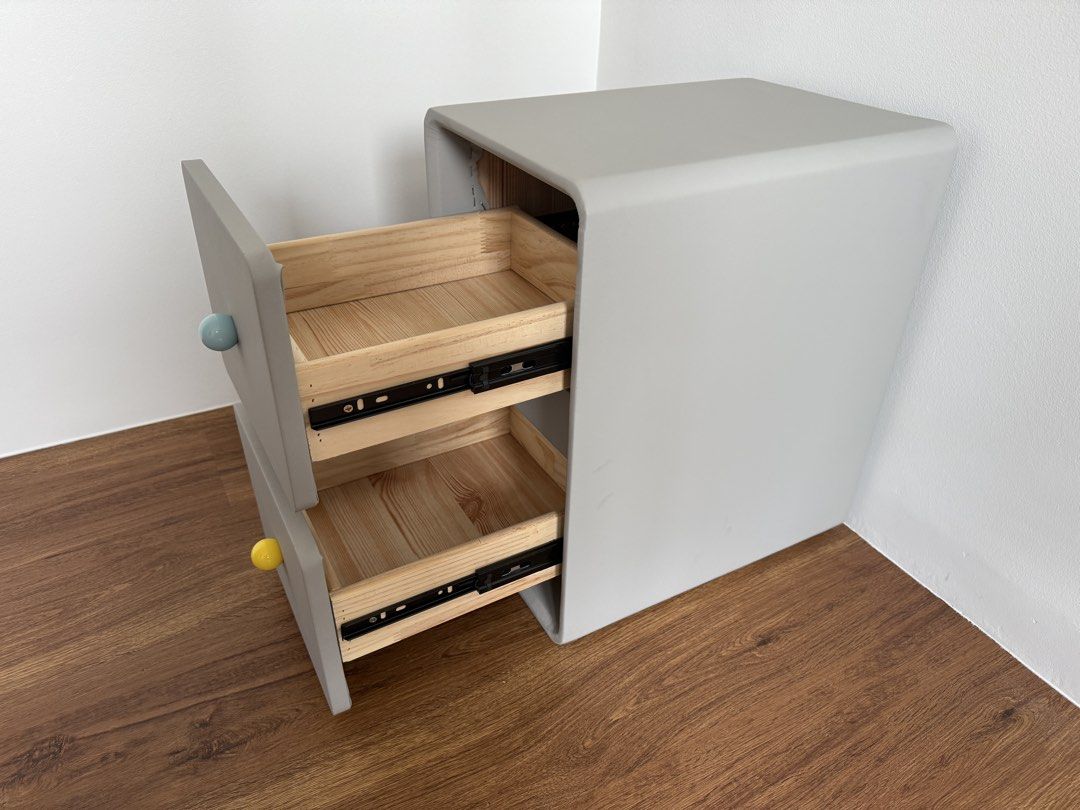 Grey 2-Drawer Bedside Table with Interchangeable Knobs (Category: Tables & Sets) located in Singapore. Submitted by jellypoop (Listing ID 1455146055, Image 3). Description: - Grey bedside table - Two smooth-gliding drawers - Comes with a set of colorful knobs (blue, yellow, pink, red, white) for customization - Dimensions: 47cm (Height) x 40cm (Width) x 30cm (Length).