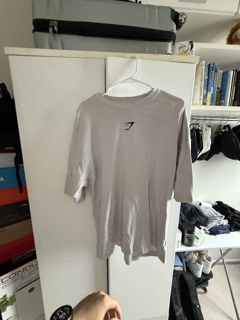 AUTHENTIC Gymshark Oversized T-Shirt Size M (Category: Activewear) located in Pasig City. Submitted by kfreed (Listing ID 1455194391, Image 1). Description: - Gymshark Grey Oversized T-Shirt - Size: Medium (M) - Small Gymshark logo on the front - Large 'HEAVY Weight' graphic print on the back - Ideal for casual wear or gym sessions RFS : I lost weight and a bit big for me now.