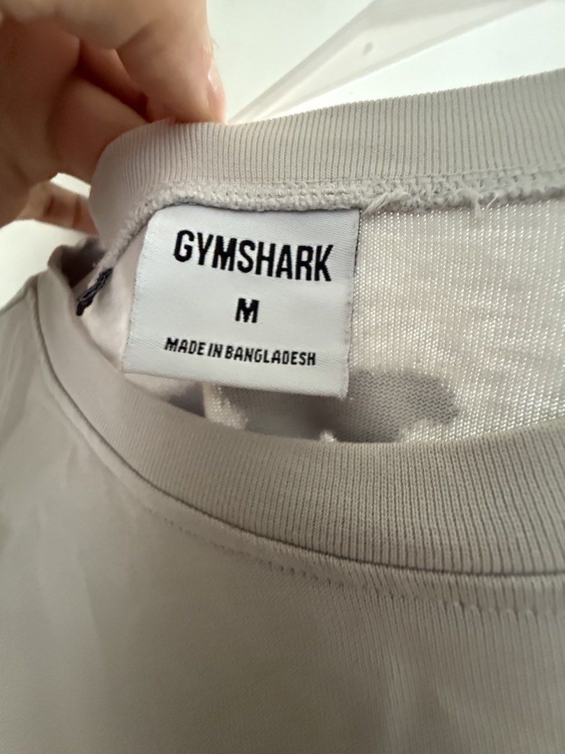 AUTHENTIC Gymshark Oversized T-Shirt Size M (Category: Activewear) located in Pasig City. Submitted by kfreed (Listing ID 1455194391, Image 2). Description: - Gymshark Grey Oversized T-Shirt - Size: Medium (M) - Small Gymshark logo on the front - Large 'HEAVY Weight' graphic print on the back - Ideal for casual wear or gym sessions RFS : I lost weight and a bit big for me now.