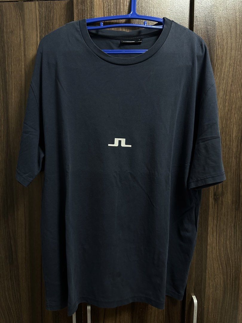 J. Lindeberg T-shirt Size M (Category: Tshirts & Polo Shirts ) located in General Trias. Submitted by jd_15 (Listing ID 1455302762, Image 1). Description: - Navy blue J. Lindeberg t-shirt - Features J. Lindeberg logo on the front - Text detail on the back - Made in Portugal - 100% Cotton - Size: Medium (M) 20x28.