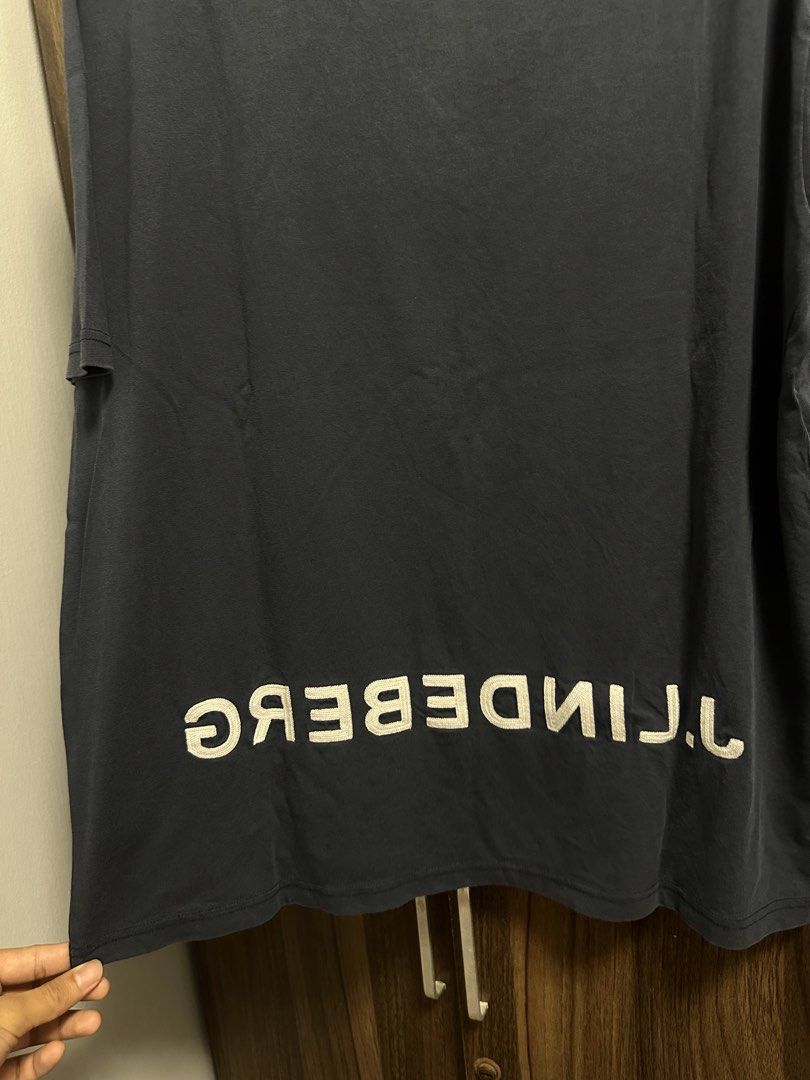 J. Lindeberg T-shirt Size M (Category: Tshirts & Polo Shirts ) located in General Trias. Submitted by jd_15 (Listing ID 1455302762, Image 2). Description: - Navy blue J. Lindeberg t-shirt - Features J. Lindeberg logo on the front - Text detail on the back - Made in Portugal - 100% Cotton - Size: Medium (M) 20x28.