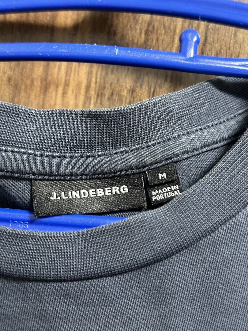 J. Lindeberg T-shirt Size M (Category: Tshirts & Polo Shirts ) located in General Trias. Submitted by jd_15 (Listing ID 1455302762, Image 3). Description: - Navy blue J. Lindeberg t-shirt - Features J. Lindeberg logo on the front - Text detail on the back - Made in Portugal - 100% Cotton - Size: Medium (M) 20x28.