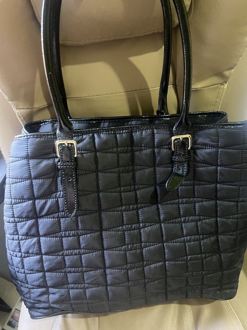 Kate Spade Black Quilted Nylon Tote Bag (Category: Tote Bags) located in Saravia. Submitted by clynlyn (Listing ID 1455196615, Image 3). Description: - Brand: Kate Spade - Material: Black quilted nylon - Details: Patent leather handles and trim - Interior: Spacious with pockets for organization - Hardware: Gold-tone - Style: Classic everyday tote bag.