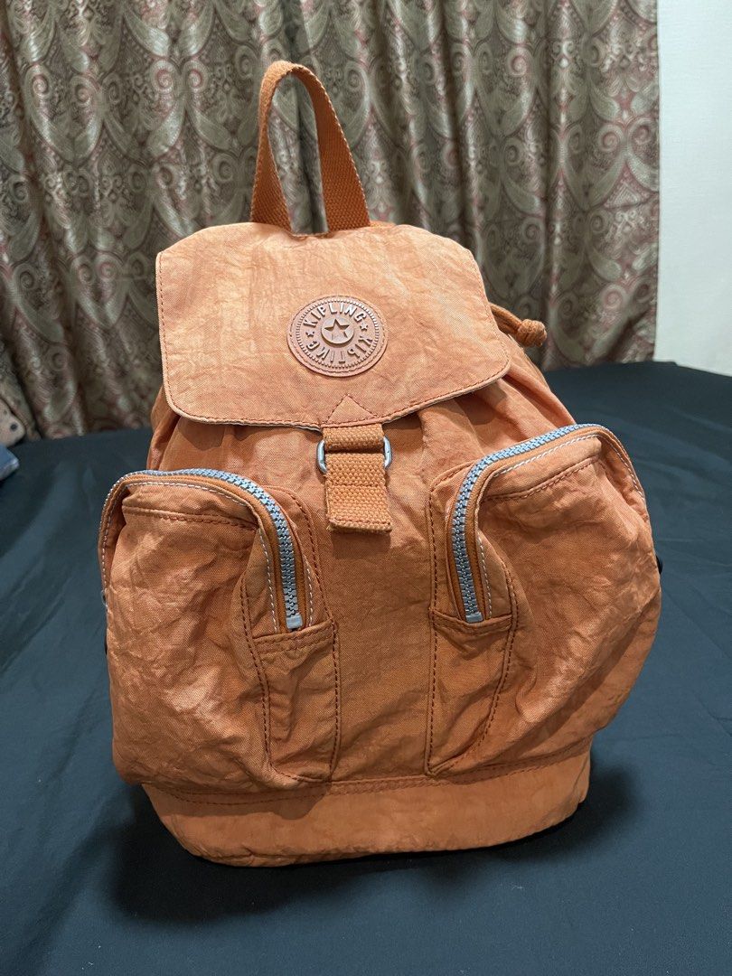 Kipling Orange Nylon Backpack (Category: Backpacks) located in Davao. Submitted by rcgulanes.moon (Listing ID 1455161055, Image 2). Description: - Orange Kipling backpack - Made of durable crinkled nylon - Secure drawstring closure under flap - Two convenient front zip pockets - Adjustable shoulder straps for comfort - Ideal for everyday adventures.