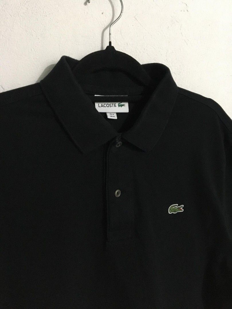 Lacoste Black Polo Shirt - Size M (Category: Tshirts & Polo Shirts ) located in Toledo. Submitted by mrb.thrift (Listing ID 1455296645, Image 3). Description: - Classic black Lacoste polo shirt - Features iconic crocodile logo on chest - Made from 100% cotton - Size: FR 4 (fits US Medium) - Versatile for casual or smart-casual wear DIMES:20-22*27 ASNEW CONDITION .