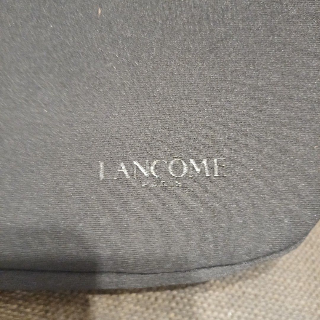 Lancome Paris Cosmetic Bag (Category: Makeup) located in Manila. Submitted by manalastas12411 (Listing ID 1455250665, Image 2). Description: - Authentic Lancome Paris makeup pouch - Stylish dark grey material with embossed logo - Secure zipper closure with branded pull tabs - Perfect size for travel or everyday essentials - Clean and well-maintained, inside and out - Ideal for organizing your makeup collection.