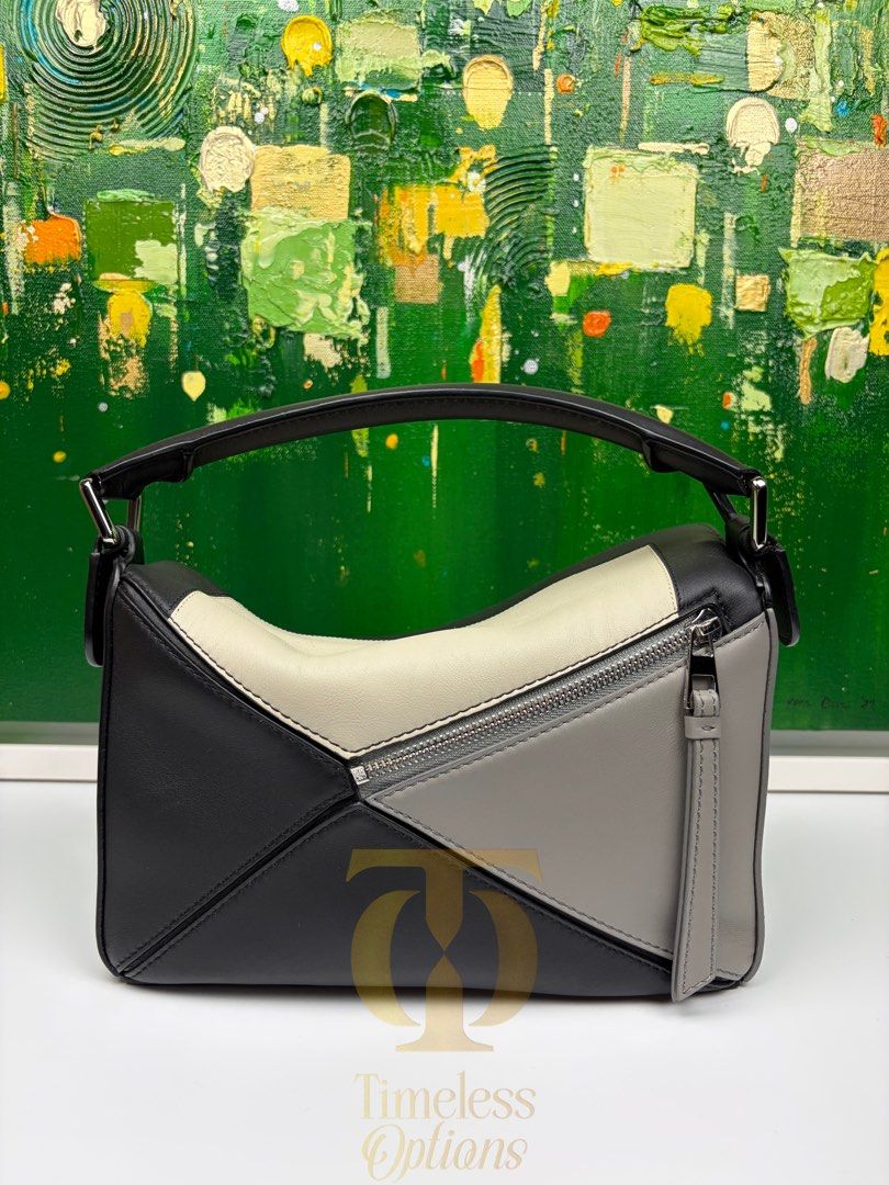 Loewe x Albers Puzzle Bag (Category: Luxury Bags & Wallets) located in Mabalacat. Submitted by to_ph (Listing ID 1455298843, Image 2). Description: ✨AVAILABLE✨ LOEWE SMALL PUZZLE BAG Best Price ₱150000 Condition: Excellent 9/10 Description: LoewexJosef Albers collaboration(limited edition)calf leather/suede lining/ black,grey,light ghost color Hardware: Silver Hardware Inclusions: dust bag, detachable leather strap,receipt Date Purchased: 2025 (D