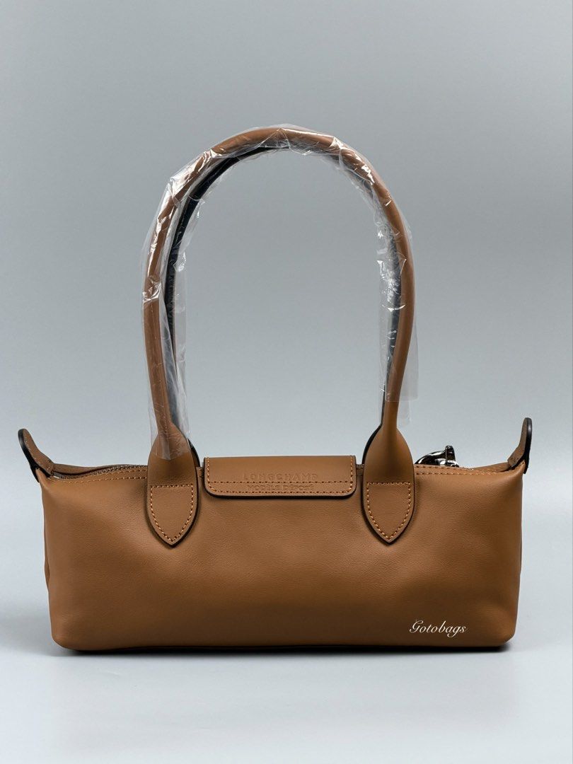 Longchamp Le Pliage S Shoulder Bag (Category: Luxury Bags & Wallets) located in Angeles City. Submitted by gobagsto (Listing ID 1455291005, Image 2). Description: - Authentic Longchamp brown leather shoulder bag - Small size - Signature embossed horse logo on flap - Zipper closure - Interior with Longchamp logo pattern - Includes dust bag and authenticity card - Handles still in original plastic wrap.