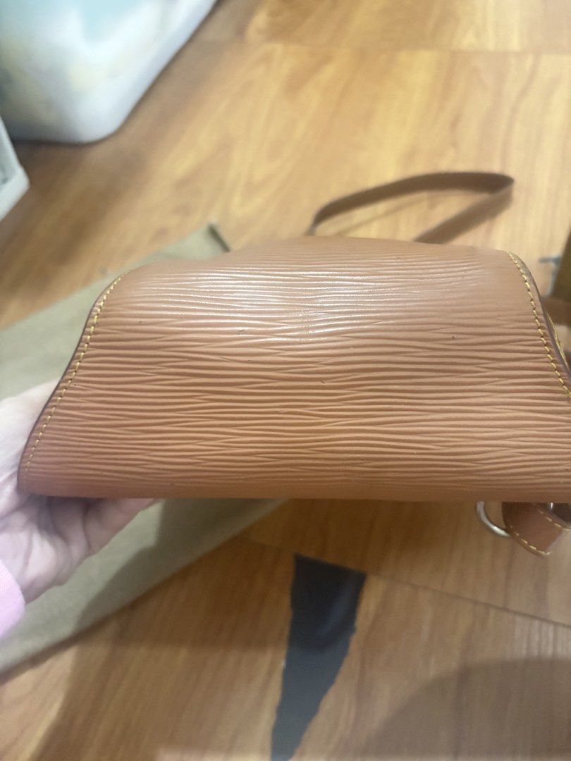Louis Vuitton Epi Leather Backpack Tan (Category: Luxury Bags & Wallets) located in Manila. Submitted by khring (Listing ID 1455242804, Image 2). Description: - Brown Louis Vuitton backpack - Epi leather material - Gold tone hardware with LV logo zipper pulls - Adjustable straps - Comes with dust bag - Great for everyday use.