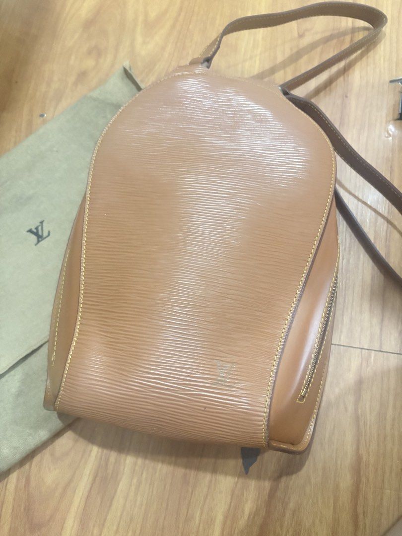 Louis Vuitton Epi Leather Backpack Tan (Category: Luxury Bags & Wallets) located in Manila. Submitted by khring (Listing ID 1455242804, Image 1). Description: - Brown Louis Vuitton backpack - Epi leather material - Gold tone hardware with LV logo zipper pulls - Adjustable straps - Comes with dust bag - Great for everyday use.