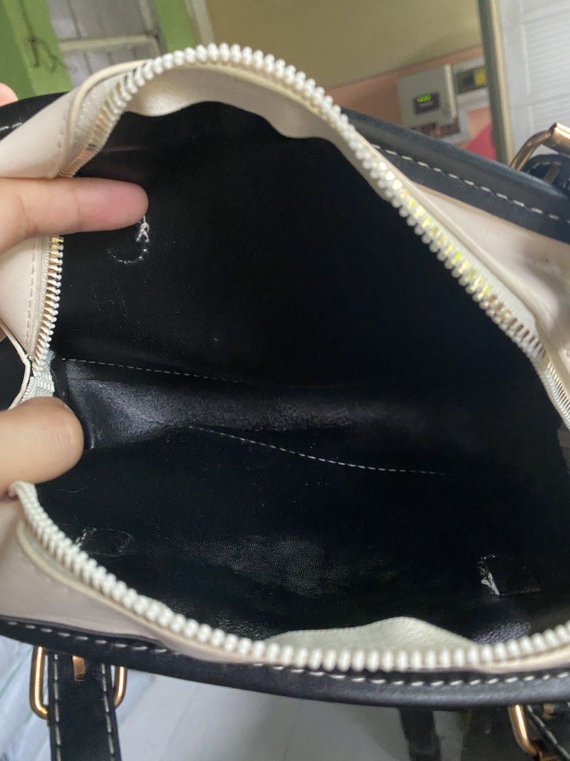 Lushlux White and Black Handbag (Category: Luxury Bags & Wallets) located in Las Pinas. Submitted by stylishchique (Listing ID 1455194224, Image 2). Description: - Stylish white and black handbag - Features a gold Lushlux logo - Secure zipper closure - Adjustable straps with buckles - Ideal size for daily necessities - Interior shows some minor marks.