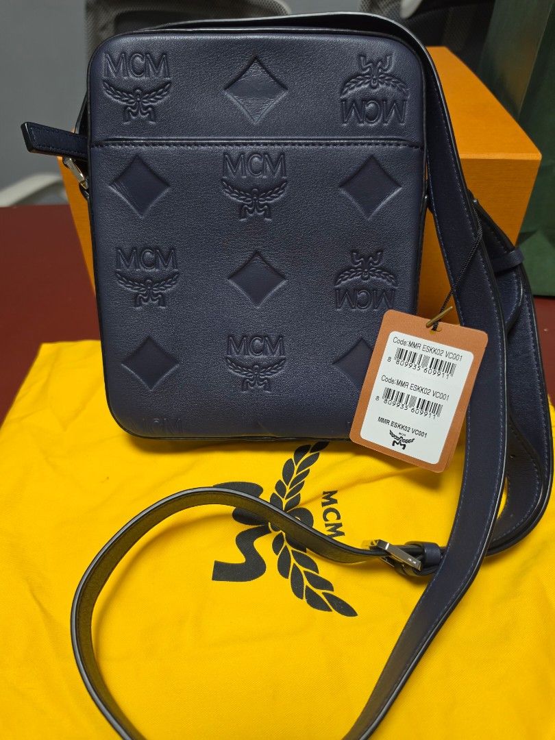 MCM Navy Leather Monogram Crossbody Bag (Category: Luxury Bags & Wallets) located in Manila. Submitted by angelyhang (Listing ID 1455244336, Image 1). Description: - Navy blue MCM crossbody bag - All-over MCM monogram pattern - Secure zip closure - Adjustable strap for comfortable wear - Comes with original dust bag and box - Ideal for everyday use Brandnew price 60K.