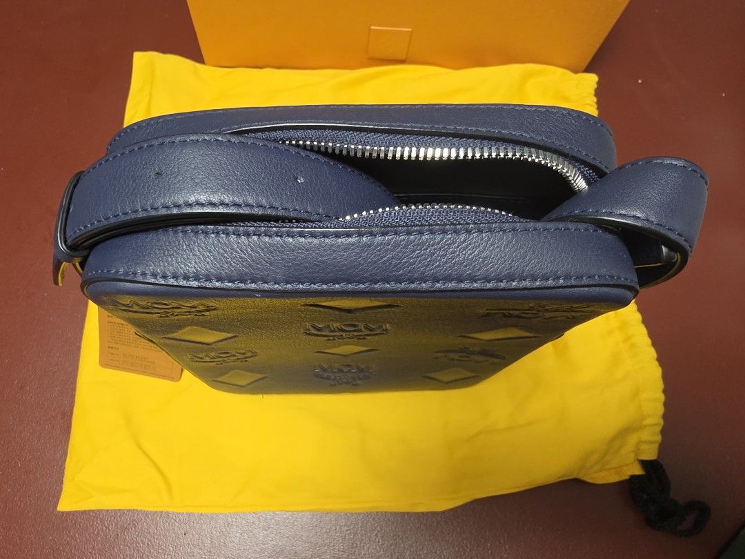 MCM Navy Leather Monogram Crossbody Bag (Category: Luxury Bags & Wallets) located in Manila. Submitted by angelyhang (Listing ID 1455244336, Image 3). Description: - Navy blue MCM crossbody bag - All-over MCM monogram pattern - Secure zip closure - Adjustable strap for comfortable wear - Comes with original dust bag and box - Ideal for everyday use Brandnew price 60K.