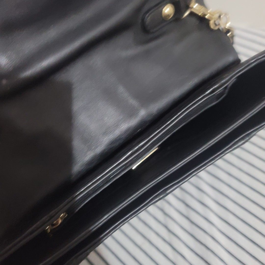 METROCITY Black Leather Embossed Chain Strap Clutch Bag (Category: Luxury Bags & Wallets) located in Pasig City. Submitted by bunny.bella (Listing ID 1455310152, Image 3). Description: Chic black leather Metrocity with gold logo. Zip closure, detachable chain strap. Perfect for essentials. Very good condition Genuine leather.