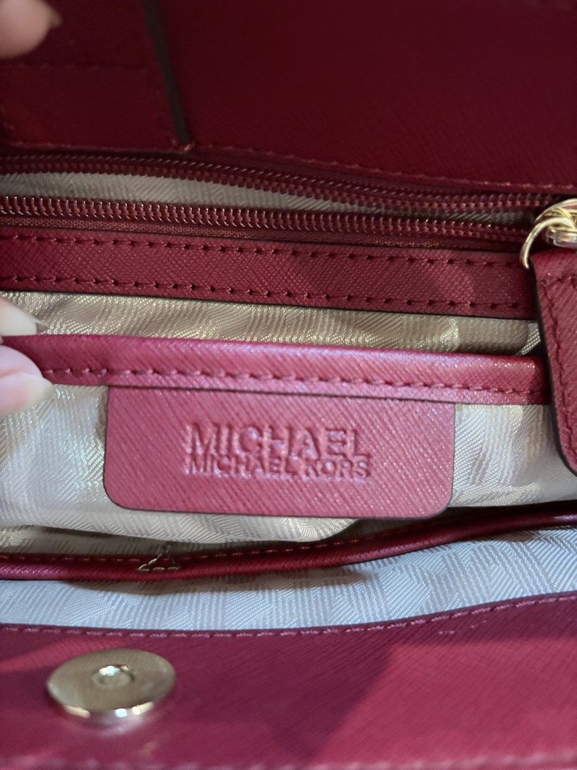 Michael Kors Red Leather Satchel Handbag (Category: Luxury Bags & Wallets) located in Caloocan City. Submitted by fierce_mica29 (Listing ID 1455199985, Image 3). Description: - Authentic Michael Kors handbag - Vibrant red color - Made from quality leather - Iconic MK logo charm - Multiple zippered compartments for organization - Stylish gold-tone hardware - Perfect for everyday use.