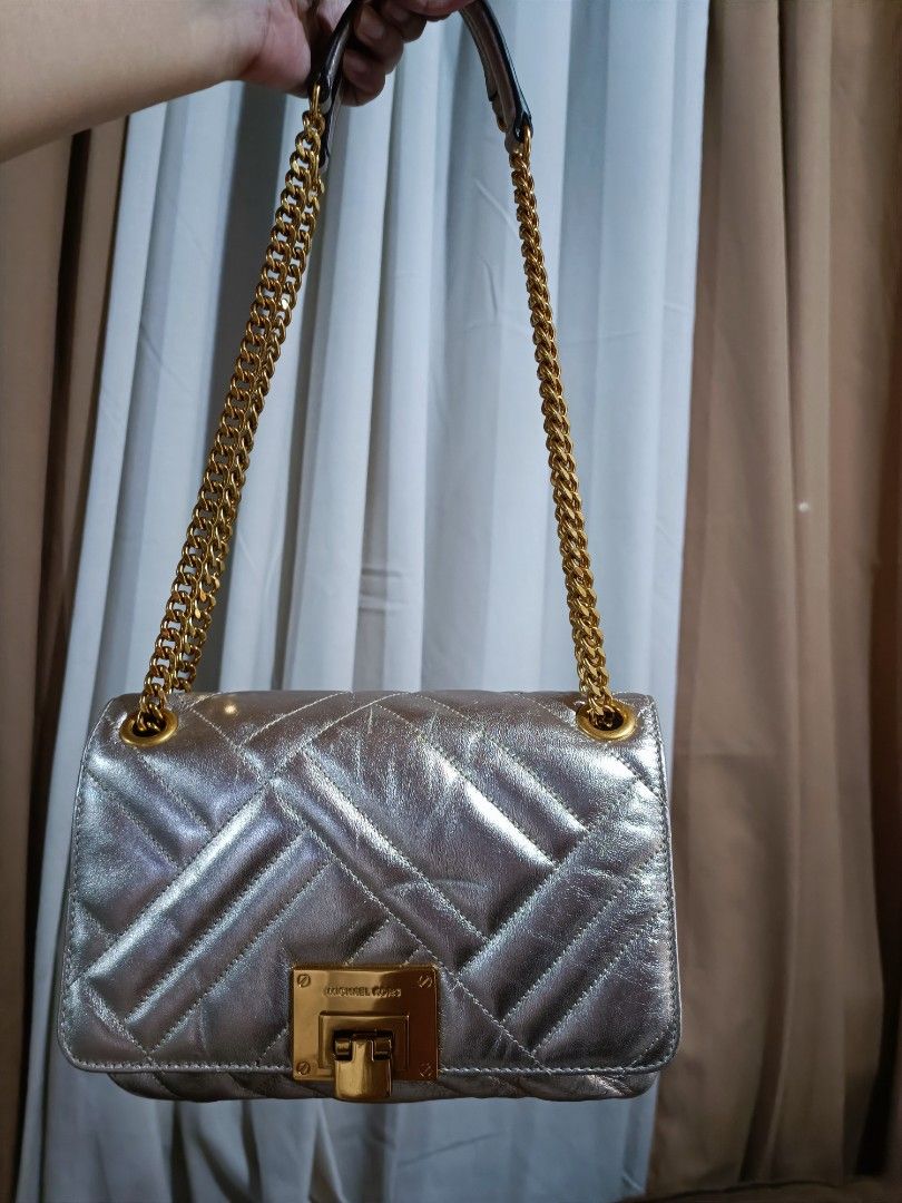 Michael Kors Vivianne Medium Shoulder Flap Bag (Category: Luxury Bags & Wallets) located in Pasig City. Submitted by charmillee (Listing ID 1455311623, Image 1). Description: •Unused item (still with tag) but stored •Japan-bought •see photos for issues (light spots on metallic leather due to storage) •clean inside •strap and hardware in like new condition •perfect as an event bag.