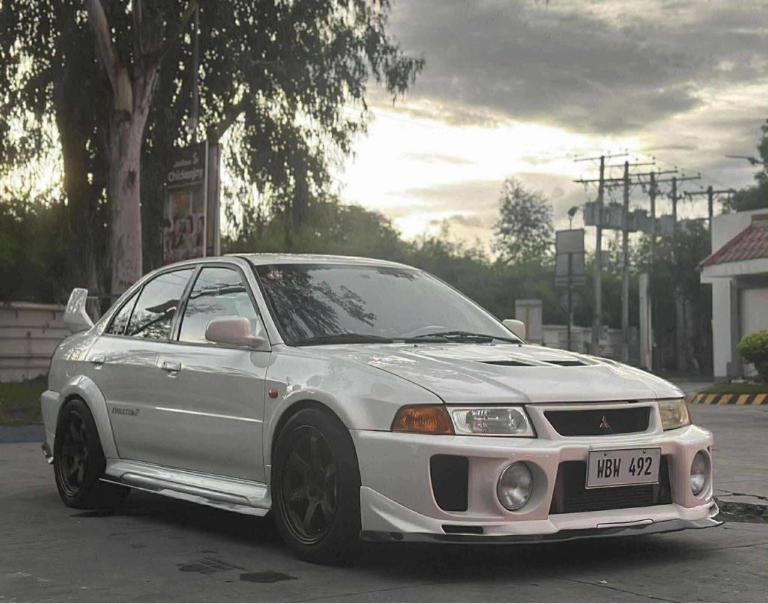 Mitsubishi Lancer Evolution-V Manual (Category: Used Cars) located in Manila. Submitted by quality_cars (Listing ID 1455240531, Image 2). Description: FORSALE‼️ 1998 Mitsubishi Lancer Evolution-V Transmission : Manual Mileage : 6,xxx Color : White Fueltype : Gas Quick specs: WBW-492 (CP9a Chassis) CP9A LHD PRS Quicksteer Japan unit (Firewall cut) Evolution 8 Engine Evolution 8 Transmission HKS Cams 272 HKS Air Intake HKS Bov Sqv HKS oil cap HKS D