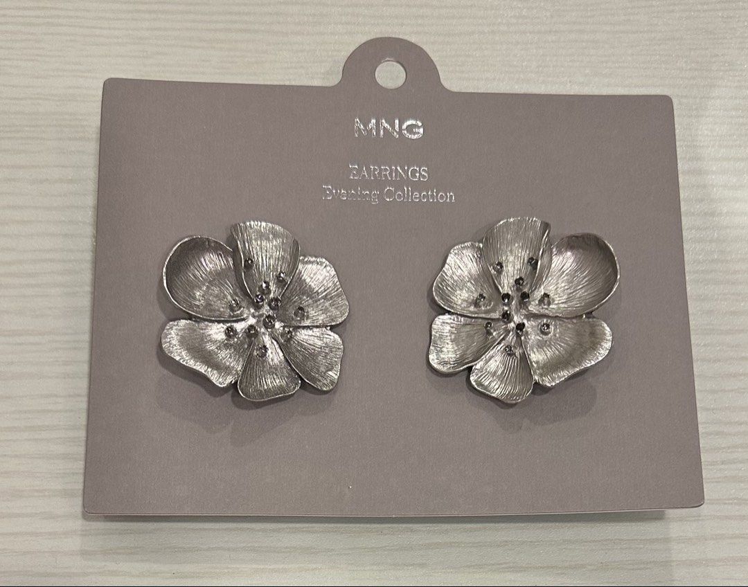 MNG Evening Collection Flower Earrings (Category: Earrings) located in Manila. Submitted by caseller26 (Listing ID 1455210221, Image 1). Description: - MNG Evening Collection earrings - Flower-shaped design - Small dark stones in the center - Silver-toned metal with textured finish - Ideal for dressing up an outfit - Brand new, never worn - Still on original card.