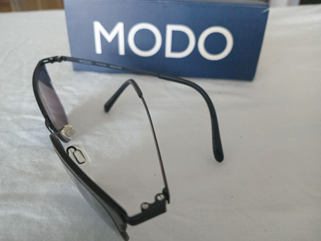 MODO Titanium Eyeglasses Model 699 BLK (Category: Sunglasses & Eyewear) located in Manila. Submitted by wildocean.cad79b (Listing ID 1455169459, Image 3). Description: - Brand: MODO Eyeglasses - Frame Material: Titanium - Model: 699 - Color: BLK (Black) - Features: Stylish, lightweight, great for everyday wear - Includes: Original MODO box - Condition: Please check photos for details.