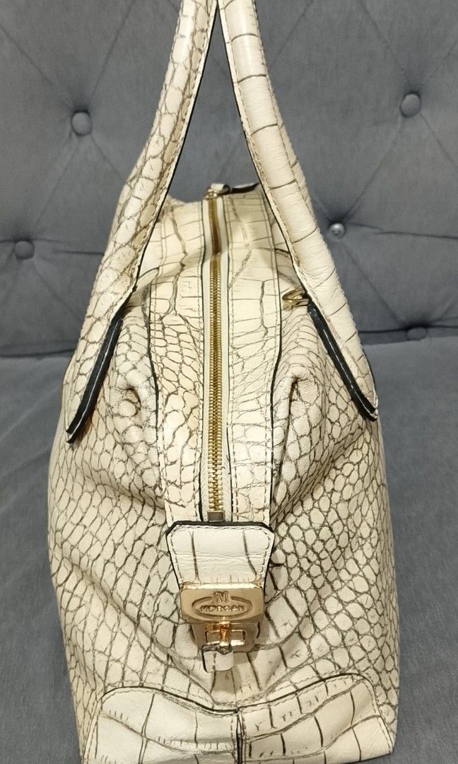 Morgan de Toi crocodile-embossed leather handbag. (Category: Shoulder Bags) located in Cavite. Submitted by authentickids_wear (Listing ID 1455291603, Image 3). Description: The item shown is a Morgan de Toi crocodile-embossed leather handbag. This structured boston/satchel bag style features a cream or off-white exterior finished with a pronounced faux-crocodile texture, distinct vertical stitched center panels, and robust twin top handles. Key 