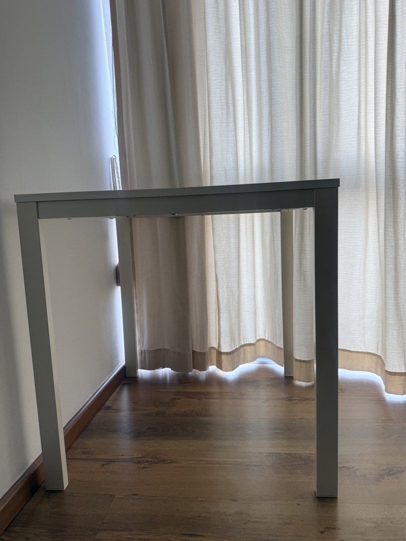 Multipurpose table (Category: Tables & Sets) located in Singapore. Submitted by pakhi6 (Listing ID 1455218639, Image 1). Description: Selling a white square study/computer table in excellent condition. * Dimensions: 74 × 74 × 74 cm * Sturdy wooden tabletop with white legs * Compact and perfect for studying, working, or as a small dining table * Clean and well-maintained * No dismantling required; can be used immediately Self-collection preferred 