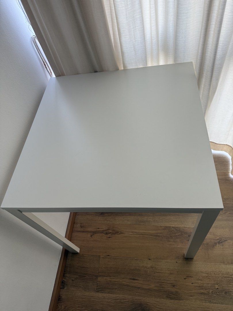 Multipurpose table (Category: Tables & Sets) located in Singapore. Submitted by pakhi6 (Listing ID 1455218639, Image 2). Description: Selling a white square study/computer table in excellent condition. * Dimensions: 74 × 74 × 74 cm * Sturdy wooden tabletop with white legs * Compact and perfect for studying, working, or as a small dining table * Clean and well-maintained * No dismantling required; can be used immediately Self-collection preferred 