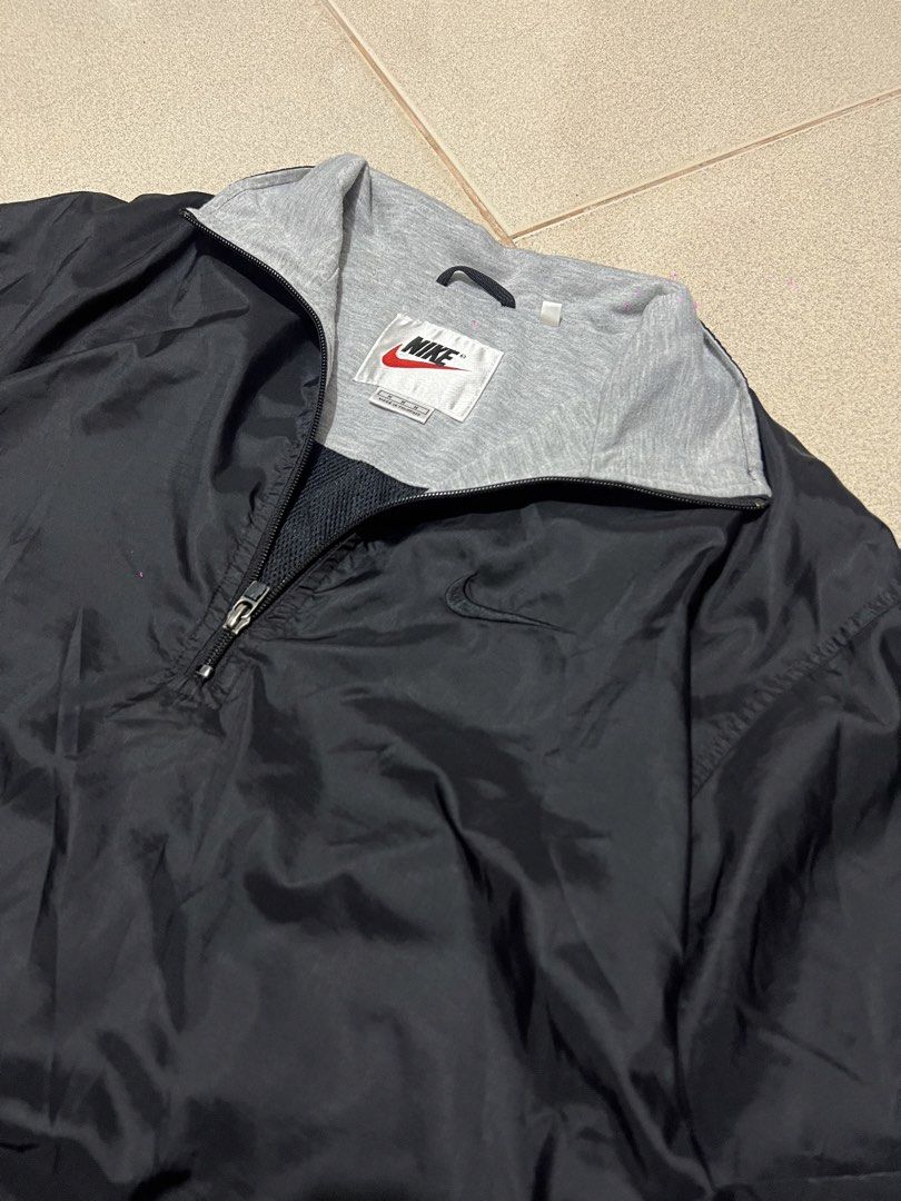 Nike 90s Pullover Windbreaker Jacket (Category: Coats, Jackets and Outerwear) located in Cebu City. Submitted by ianjoseph24 (Listing ID 1455248660, Image 2). Description: - Vintage Nike windbreaker from the 90s - XL FRAME - Black nylon shell with grey jersey lining - Quarter zip closure - Embroidered classic Nike swoosh logo on chest - Ideal for casual wear or sports activities.