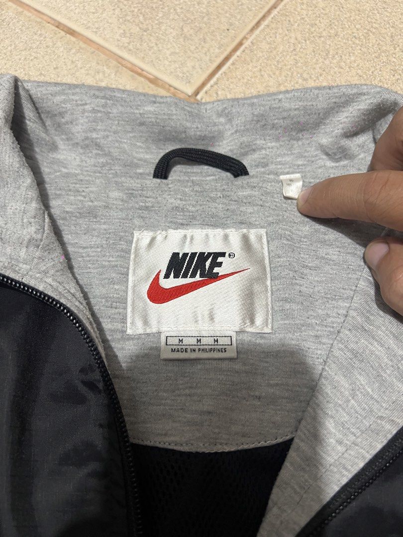 Nike 90s Pullover Windbreaker Jacket (Category: Coats, Jackets and Outerwear) located in Cebu City. Submitted by ianjoseph24 (Listing ID 1455248660, Image 3). Description: - Vintage Nike windbreaker from the 90s - XL FRAME - Black nylon shell with grey jersey lining - Quarter zip closure - Embroidered classic Nike swoosh logo on chest - Ideal for casual wear or sports activities.