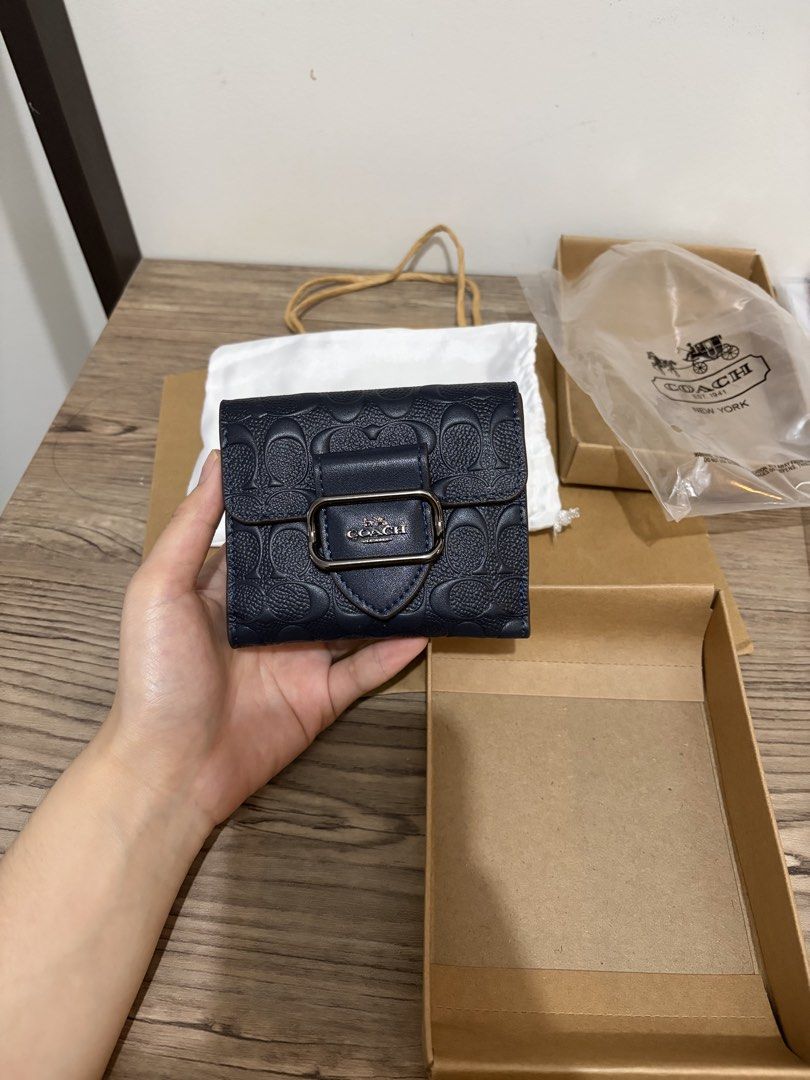 Original Coach Morgan Wallet (Category: Luxury Bags & Wallets) located in Pasay City. Submitted by eudaimonia_0894 (Listing ID 1455267470, Image 3). Description: - Navy blue Coach wallet - Signature embossed C logo all over leather - Buckle closure with Coach horse and carriage logo - Interior card slots and coin pocket - Comes with original packaging - Ideal for everyday use This is an original Coach outlet wallet. I never used this wallet so th