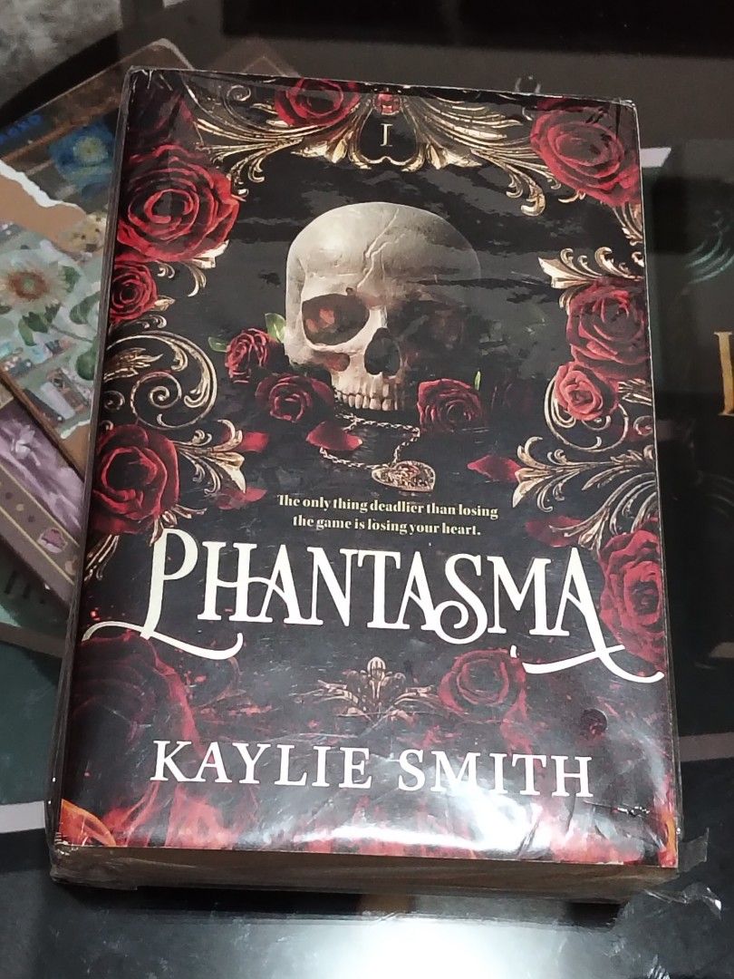 PHANTASMA by Kaylie Smith (Category: Storybooks) located in Manila. Submitted by shajii (Listing ID 1455296446, Image 1). Description: PHANTASMA - Author: Kaylie Smith - Genre: Dark Fantasy / Thriller - Cover Design: Features a skull and roses motif - Tagline: "The only thing deadlier than losing the game is losing your heart." - Ideal For: Fans of dark fantasy and thrillers binasa lang onti lolll. can send more pics ~ sdd, jnt or meet up gcash, 