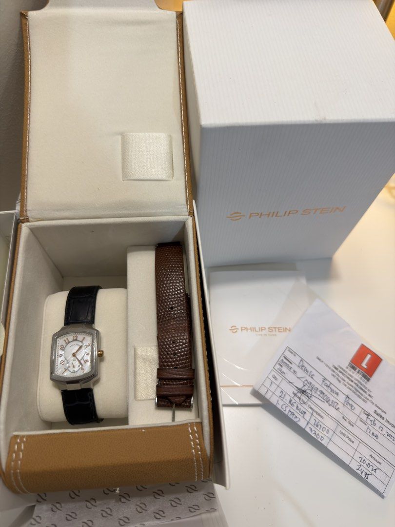 Philip Stein Two-Tone Watch with Leather Strap (Category: Women's Watches) located in Manila. Submitted by DocDenP (Listing ID 1455264536, Image 2). Description: - Authentic Philip Stein watch - Elegant silver dial with Roman numeral hour markers/ Mother of Pearl - Features a convenient sub-dial - Comes with original Philip Stein box - Includes an extra brown leather strap for versatility - Purchase receipt dated February 12, 2022, is included - 
