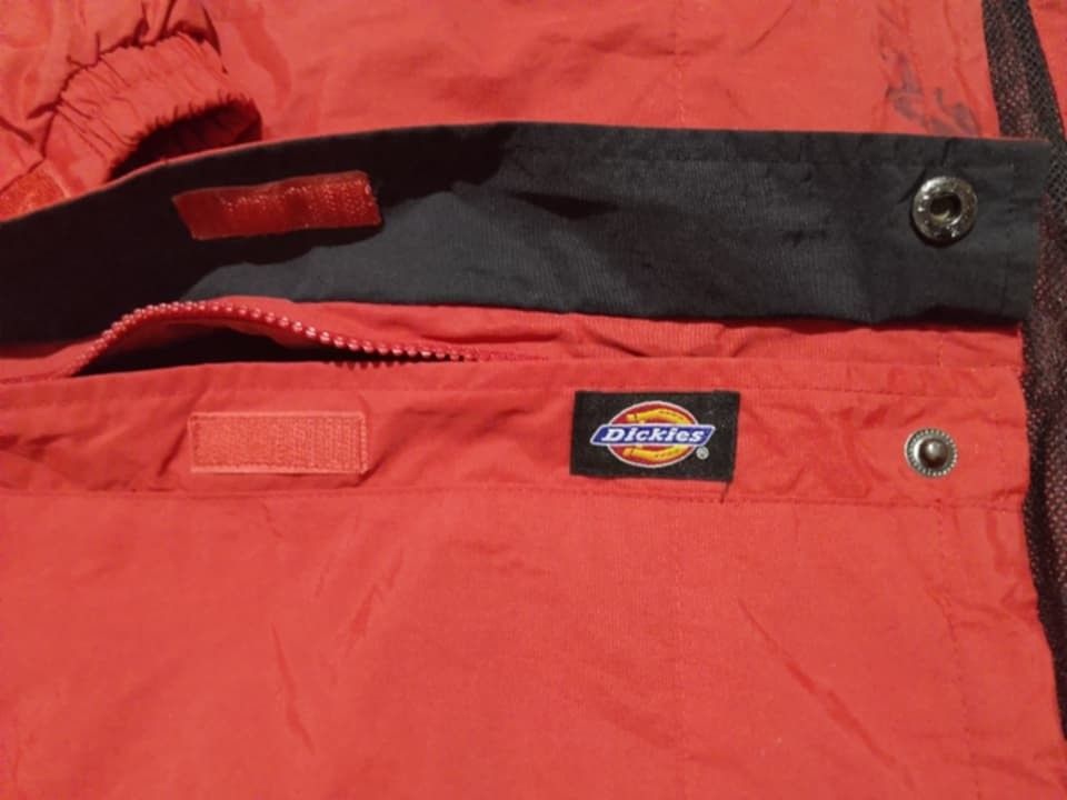 Red Dickies Men's Waterproof Outdoor Rain Jacket / Gorpcore Windbreaker (Category: Coats, Jackets and Outerwear) located in Iloilo. Submitted by stayc. (Listing ID 1455307622, Image 3). Description: designed for weather protection. It features an adjustable integrated hood, a full-front zipper with a protective storm flap, adjustable velcro cuffs, and secure side zip pockets note :it has stains as seen in the picture not sure if it is washable.