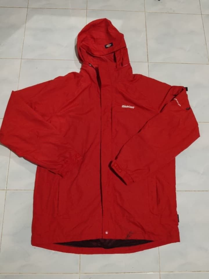Red Dickies Men's Waterproof Outdoor Rain Jacket / Gorpcore Windbreaker (Category: Coats, Jackets and Outerwear) located in Iloilo. Submitted by stayc. (Listing ID 1455307622, Image 1). Description: designed for weather protection. It features an adjustable integrated hood, a full-front zipper with a protective storm flap, adjustable velcro cuffs, and secure side zip pockets note :it has stains as seen in the picture not sure if it is washable.