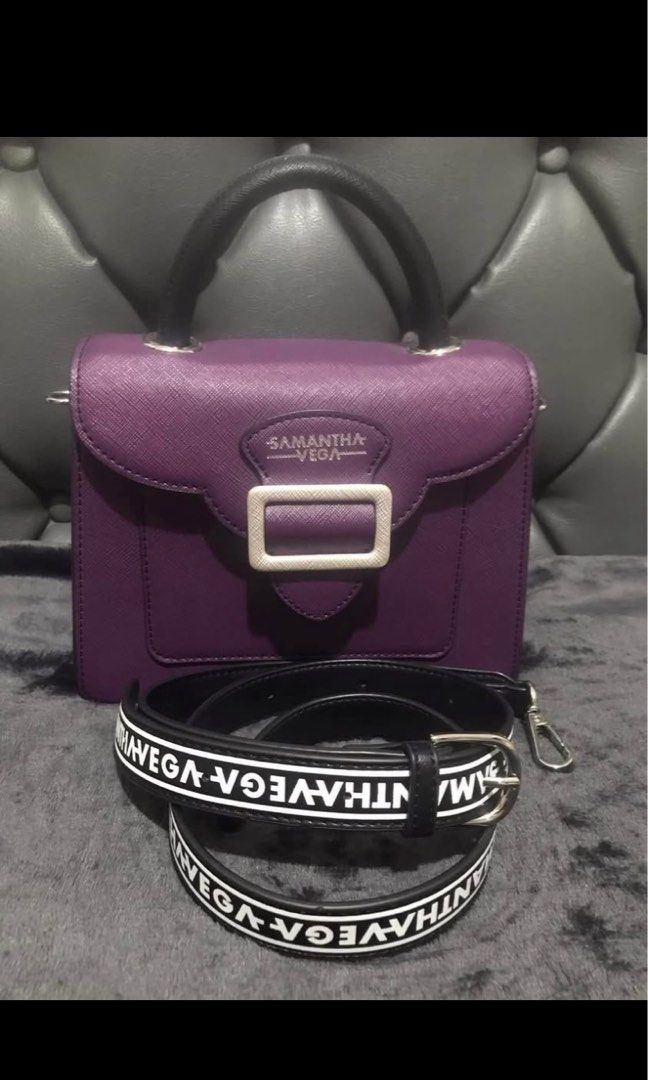 Samantha Vega Purple Structured Handbag with Strap (Category: Luxury Bags & Wallets) located in Manila. Submitted by inah.kei (Listing ID 1455255514, Image 1). Description: - Samantha Vega structured handbag in purple - Top handle and detachable shoulder strap with logo print - Secure buckle closure on front flap - Interior with multiple compartments - Elegant silver hardware details - Versatile for everyday or special occasions ko.