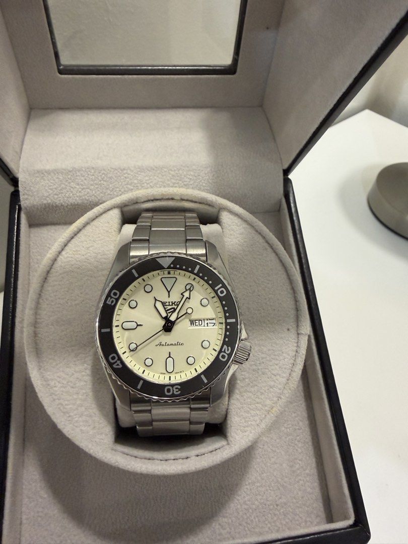 Seiko 5 Automatic Watch Cream Dial (Category: Men's Watches) located in Manila. Submitted by DocDenP (Listing ID 1455264902, Image 1). Description: - Seiko 5 Automatic Watch - Cream dial with black bezel - Includes original box and papers - Purchased from SM Store - Watch Serial Number: 212228 - Case Number: 4R36-0829 - Still has original price tag attached - Ideal for everyday use.