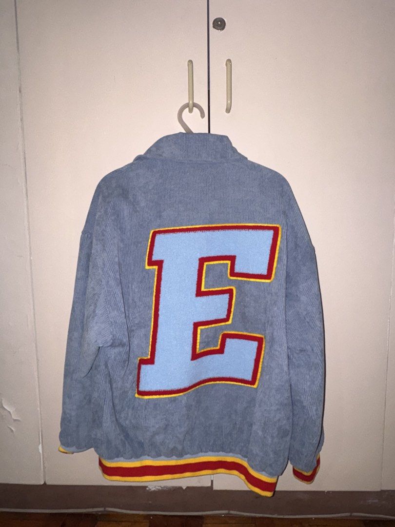 Smyth Corduroy Varsity Jacket with 'E' and 'S' Patches (Category: Coats, Jackets and Outerwear) located in Manila. Submitted by snorluxxx24 (Listing ID 1455242644, Image 3). Description: - Smyth light blue corduroy jacket - Size: Medium (M) - Large 'E' patch on back - Smaller 'S' patch on sleeve - Ribbed cuffs and hem with red and yellow stripes - Button-up front - Ideal for a casual, retro aesthetic.
