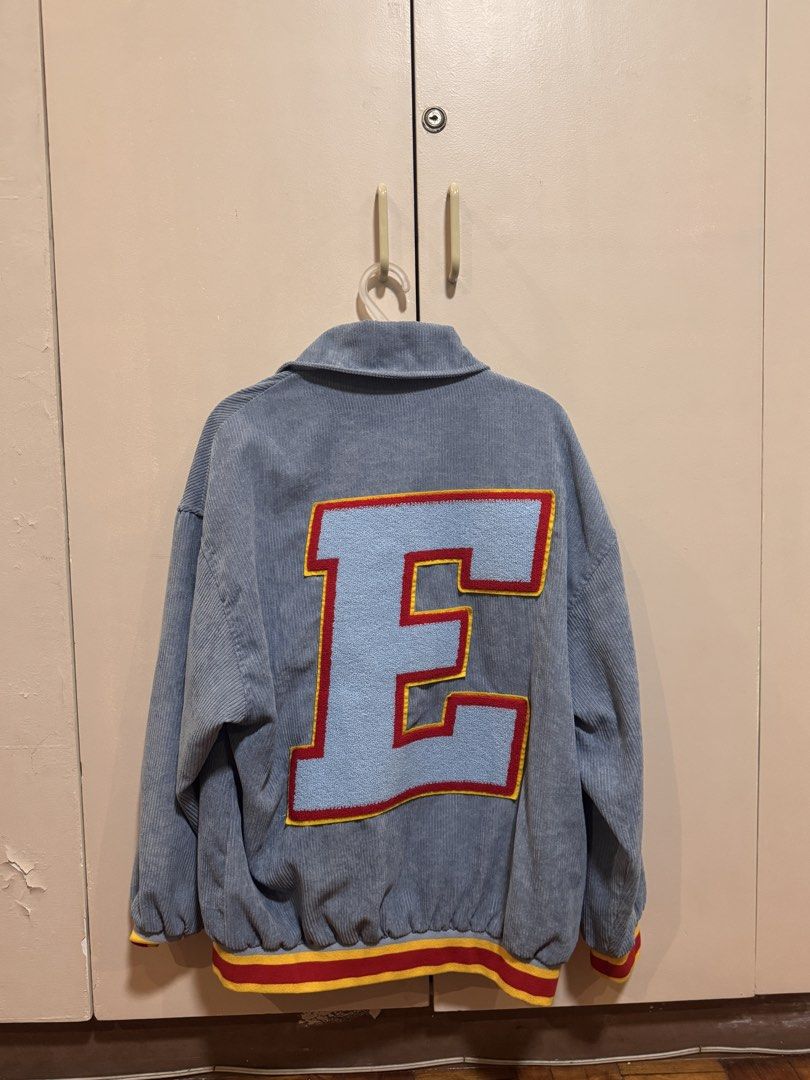 Smyth Corduroy Varsity Jacket with 'E' and 'S' Patches (Category: Coats, Jackets and Outerwear) located in Manila. Submitted by snorluxxx24 (Listing ID 1455242644, Image 2). Description: - Smyth light blue corduroy jacket - Size: Medium (M) - Large 'E' patch on back - Smaller 'S' patch on sleeve - Ribbed cuffs and hem with red and yellow stripes - Button-up front - Ideal for a casual, retro aesthetic.