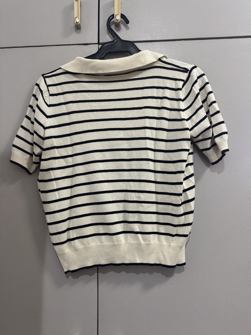 Striped Polo Collar Cropped Knit Top (Category: Blouses) located in Quezon City. Submitted by jaebaeee (Listing ID 1455289201, Image 2). Description: - Cream and black striped knit fabric - Short sleeves - Classic polo collar - Trendy cropped length - Super comfy and stylish - Versatile for casual or slightly dressed-up outfits - Easy to pair with jeans or skirts.