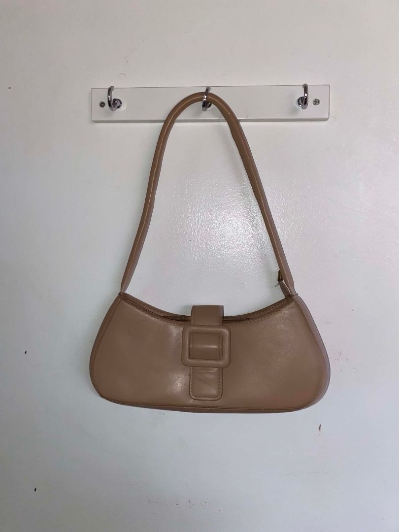 Tan shoulder bag with buckle detail (Category: Shoulder Bags) located in Marikina City. Submitted by dwsnts (Listing ID 1455249517, Image 1). Description: - Adjustable strap - Ideal for everyday use - Used twice, still in great condition.