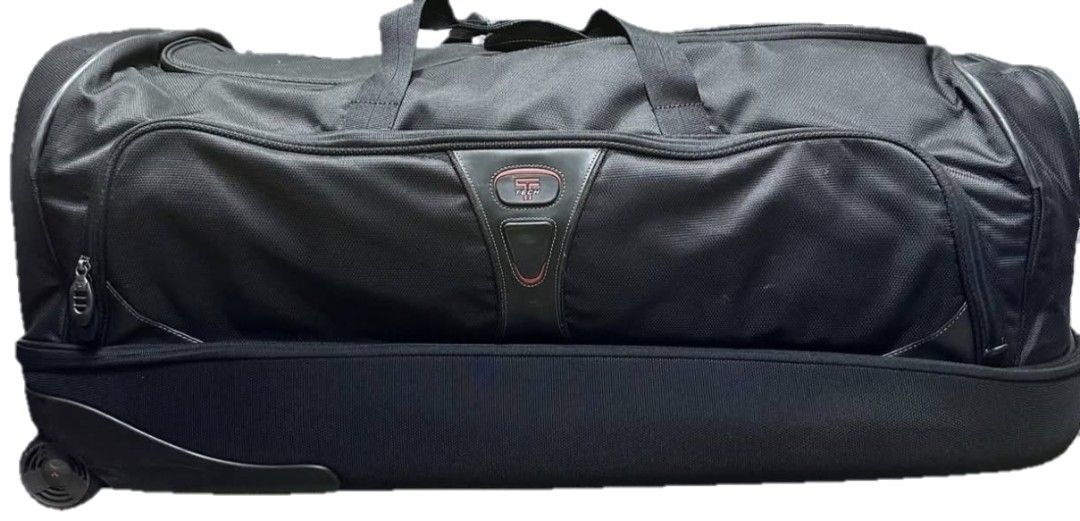 TUMI Black Wheeled Duffel Bag Luggage (Category: Luxury Bags & Wallets) located in Iloilo. Submitted by blancroger_tumi (Listing ID 1455166017, Image 2). Description: - TUMI-Tech wheeled duffel bag - Ample interior space for all your travel needs - Features comfortable grab handles and an adjustable shoulder strap - Smooth-working zippers for secure closure - Durable wheels for effortless transportation - Ideal for weekend getaways or extended va